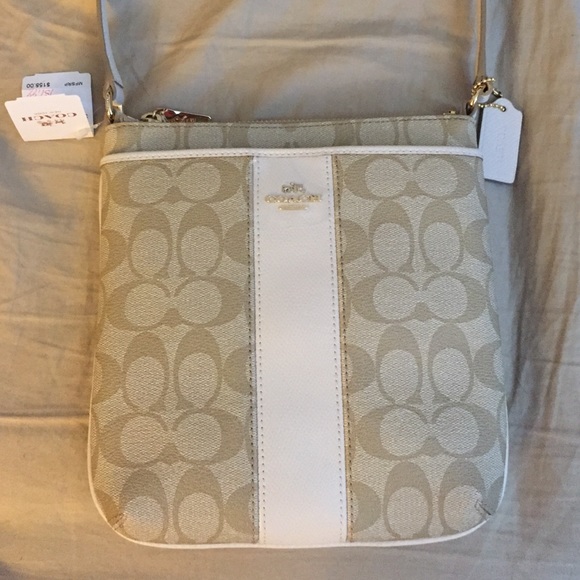 A neutral and white cross body Authentic Coach.