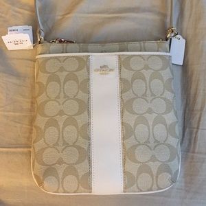 A neutral and white cross body Authentic Coach.