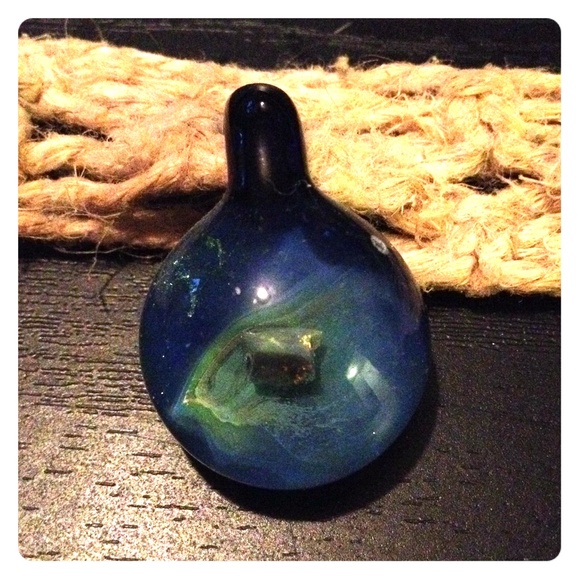 Blue glass bead with mineral