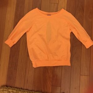 Peach colored sweat shirt with cut out back