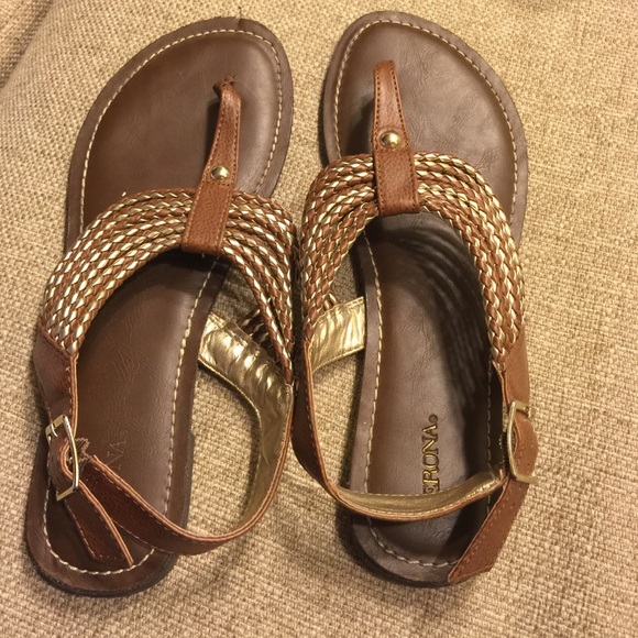 Brown and gold flip flops