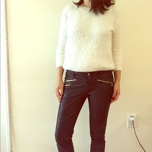 A white mohair sweater that has been lightly worn.