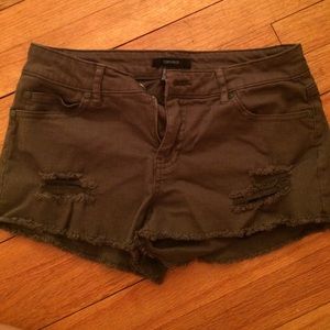 Dark green shorts with studs on back pockets