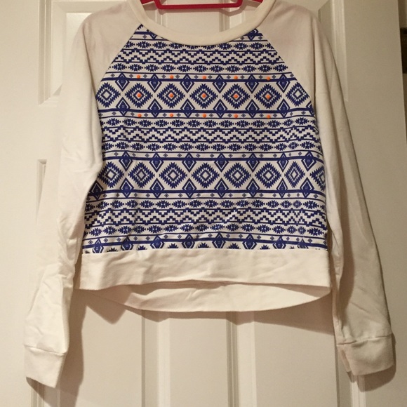 white sweater with blue pattern and orange dots