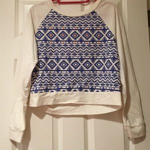 white sweater with blue pattern and orange dots