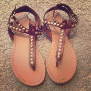 Brown sandals with gold accents