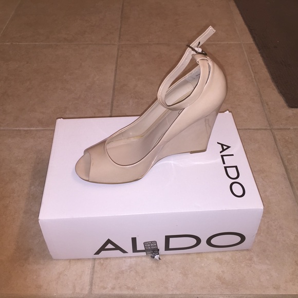 Nude open toe ankle strap wedges.