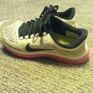 Pink & white nike free runs.