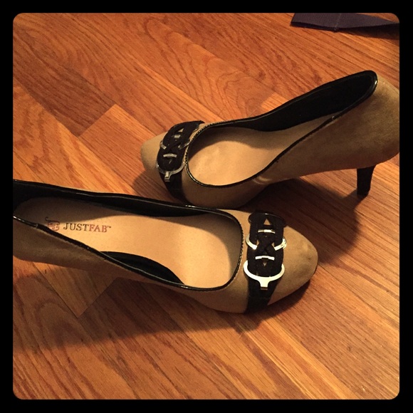 Tan and black high heels, with detail on toes