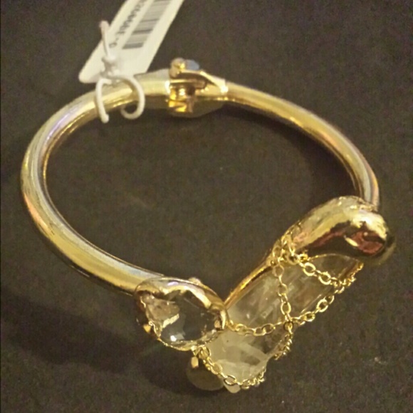 Gold tone cuff bracelet with clear stones