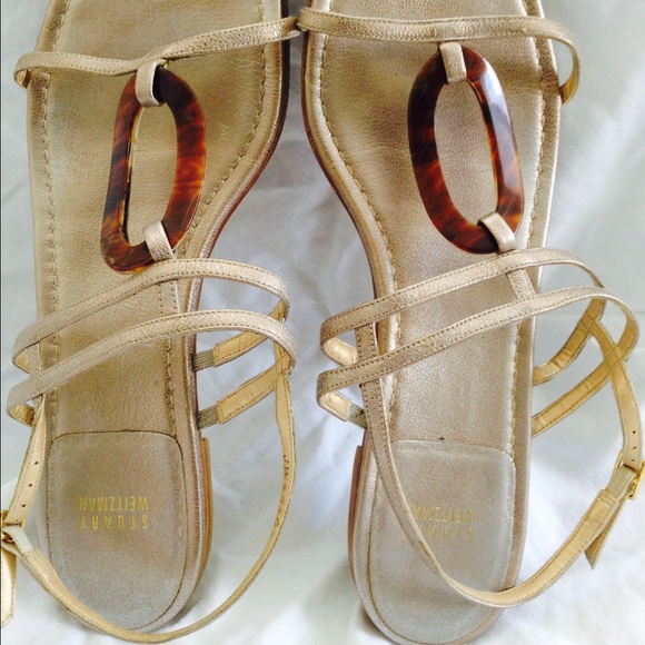Flat pale gold sandals.