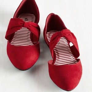 Point-toe, faux suede ruby red flats.