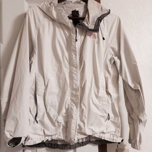 White Northface rain jacket with light pink decal