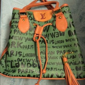 Green drawstring bucket style handbag.