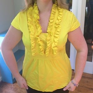 Bright yellow ruffled top.
