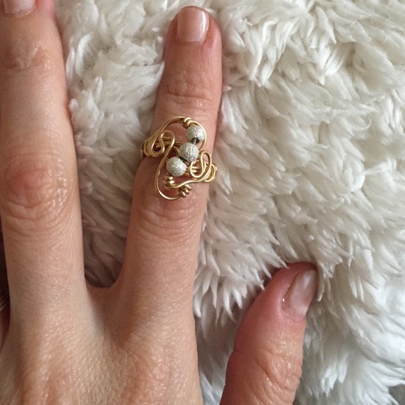 Gold wire ring with silver sphere accents.
