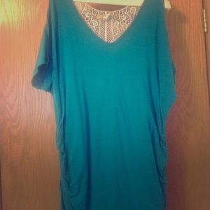 Long teal blue shirt with open white back.