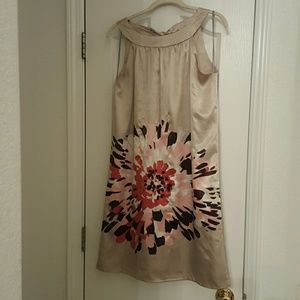 A champagne colored dress with a lining