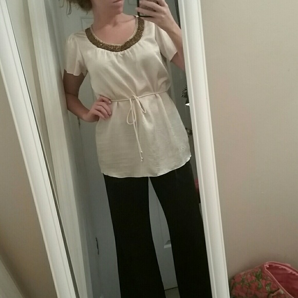 Cream dressy top with gold beading.