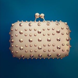Gold studded hard-cased clutch.