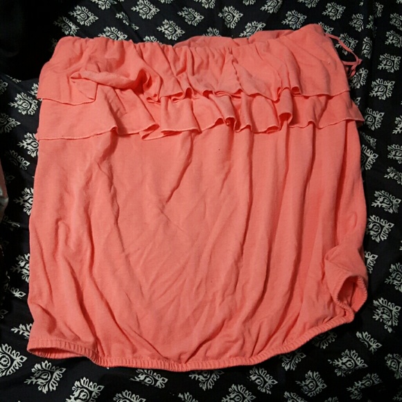 A coral colored strapless top.