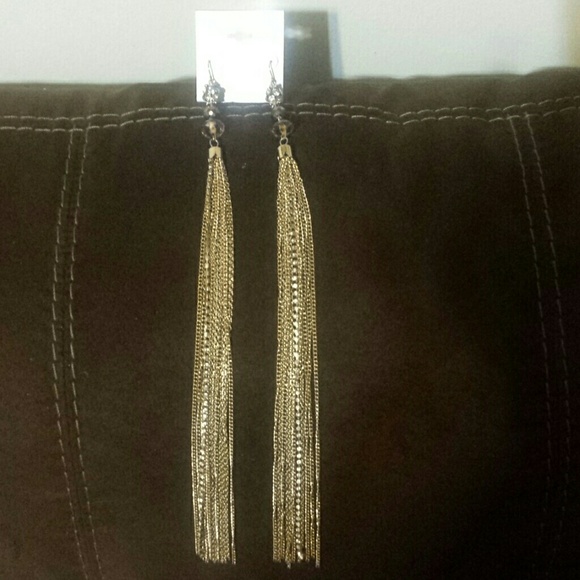 Long gold earring by Baker