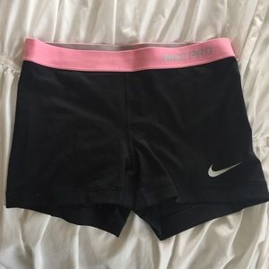 Pink and black nike pro shorts