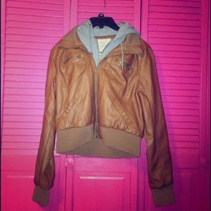 Brown leather jacket with grey sweatshirt inside