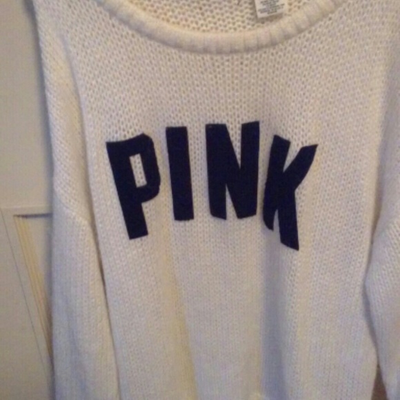 White sweater with pink name on  it