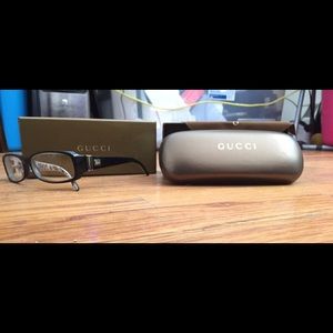 Black Gucci eyeglasses with accessories.