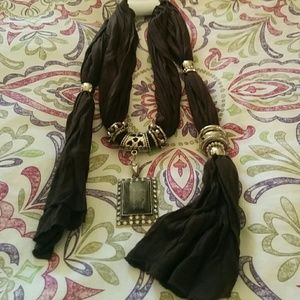 Brown embellished scarf with jewelry accents.