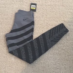 Grey Nike Leggings with black stripes.