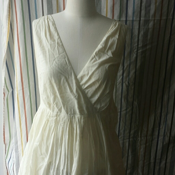 Off white dress with detail in the bottom hem