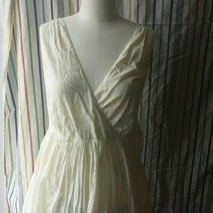 Off white dress with detail in the bottom hem