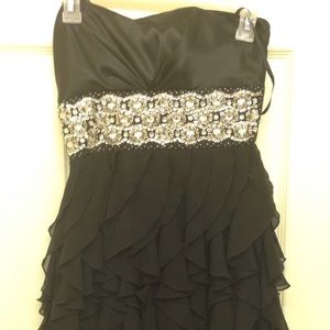 Short black strapless dress with embellishments