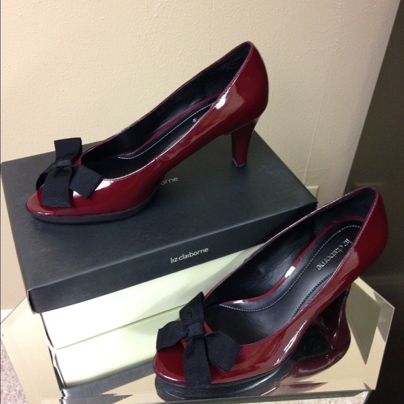 Wine color patent leather pump with black ribbon.
