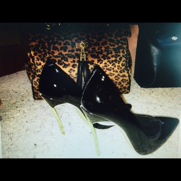 Women's black high heel shoes with gold heel.