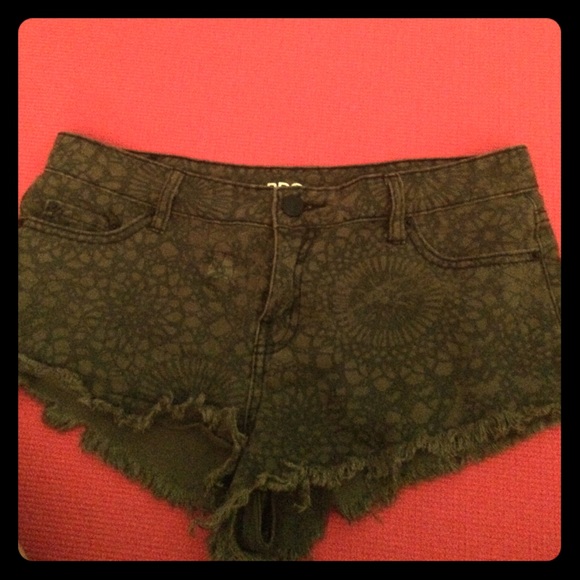 Green with black pattern shorts. Low rise.