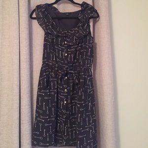 Navy dress with white key print and gold buttons