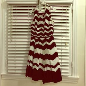 Black and white dress with pleats and pockets.