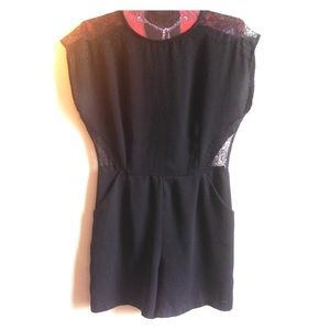 Black romper with lace detail.