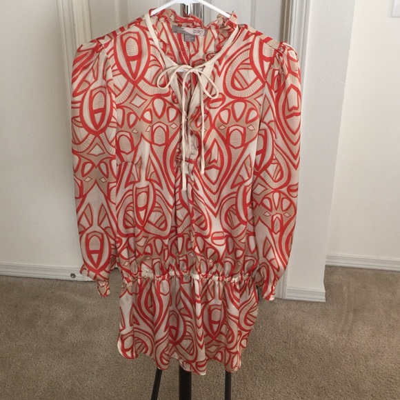Tunic style blouse that gathers at the hip.