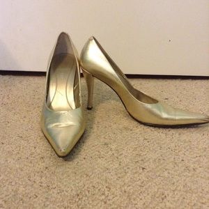 Gold Nine West pointed toe pumps. Size nine.