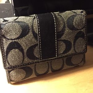 Black and grey coach wallet.