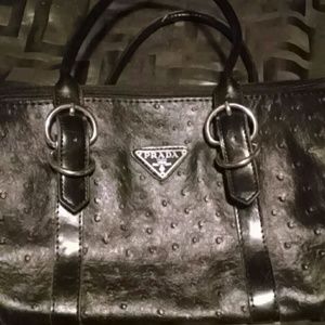 Black bag....Prada knockoff maybe...not sure.