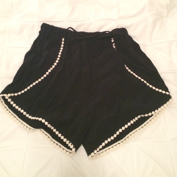 Black shorts with white Pom Pom detail