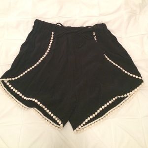 Black shorts with white Pom Pom detail