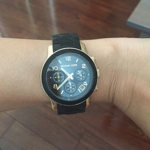 Like new Michael Kors black and gold watch