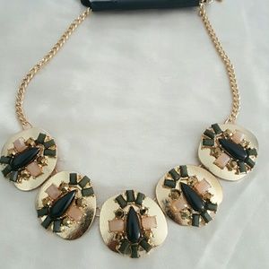 Gold necklace with stones.