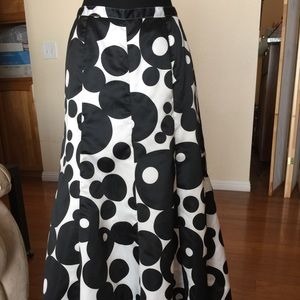 Floor length, silky black and white skirt.